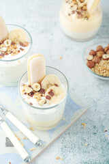 Milk mousse dessert with nuts in glasses	