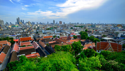 Aerial cityscape view with red temple roofs and skyline