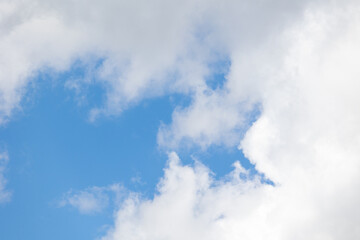 White clouds drifting across a vibrant blue sky