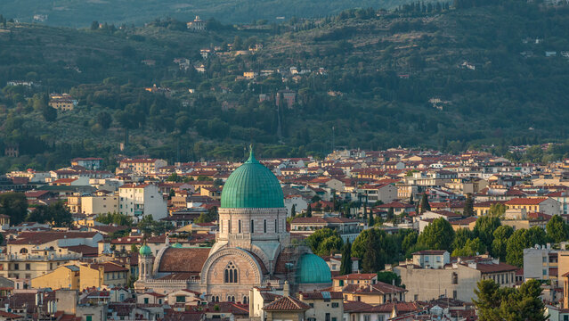 Synagogue of Florence timelapse with green copper dome rising above surrounding suburban housing with green hillside