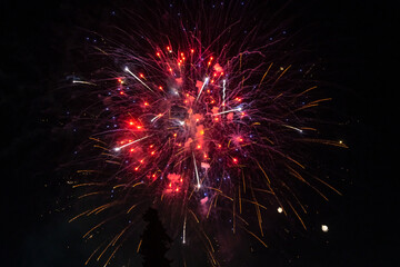 Holiday fireworks explode in the night sky. 4th of July celebration. Selective focus. 