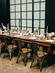Elegant dining setup with floral centerpieces and candlelight for a special occasion in a modern venue