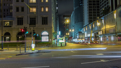 Obraz premium Neon lights on Tsim Sha Tsui street timelapse hyperlapse with traffic near Pehinsula.