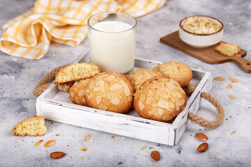 Delicious homemade butter cookies with almond petals, served with glass of milk