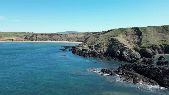 Whistling Sands Beach, North Wales, drone strafing left across a picturesque sandy bay