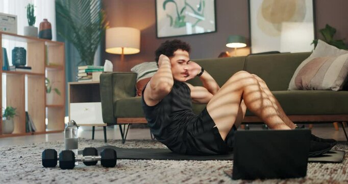 Home, crunches and man with fitness, training routine and workout with endurance, wellness and laptop. Apartment, healthy person and athlete in lounge, energy and exercise with core strengthening