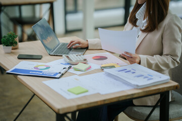 Close up of business asian woman hand typing on laptop computer, searching and surfing the internet on office desk, online working, telecommuting, freelancer at work concept