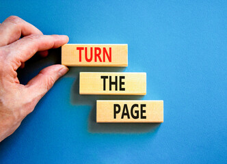 Turn the page symbol. Concept words Turn the page on beautiful wooden block. Businessman's hand....