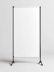 A white sign is standing on a grey surface. The sign is tall and has a black pole