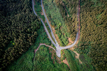  Aerial view of The Vee Pass winding through the Knockmealdown Mountains, showcasing stunning Irish landscape, vibrant greenery, and dramatic elevation in County Tipperary, Ireland.