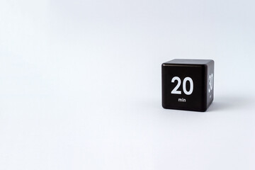 Black cube timer with 20 and 30 minutes sign on white background. Minimal interval time concept. Copy space, selective focus