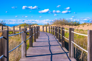 Wooden footbridge leading to fangar beach in ebro delta natural park