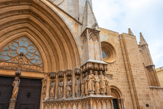 Tarragona cathedral main entrance showing stone sculptures and architectural details