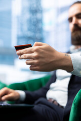 Business professional manages corporate finances verifying budget details and making electronic payments, showcasing responsible money management. Success story with an enterprise.