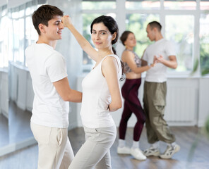 Fototapeta premium Club for those who like to dance for their own pleasure, non-professional dancing performers enjoy social pair dance salsa during rehearsal in studio