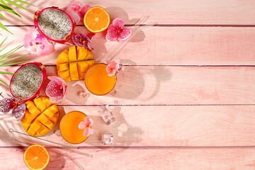 Sunny tropical banner, background with cocktails and juices from citrus, dragon fruit and mango....