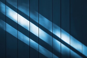 Fototapeta premium Sunlit Shadows Creating Stripes on Blue Wall and Wooden Floor