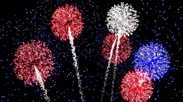 Vibrant fireworks display against night sky with red, white, blue bursts