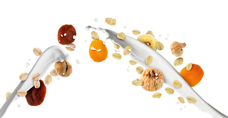 Milk splash with oat flakes and dried fruits in air on white background. Healthy breakfast