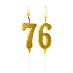 Burning golden cake candles composing number 76 on white background. Festive decoration for birthday or other special date