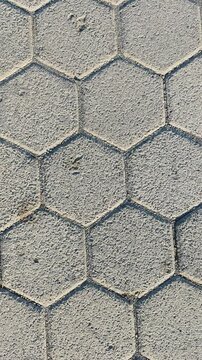 Close-up view of a textured hexagonal paving stone pattern with stone work civil engineering stone pavement cut stone