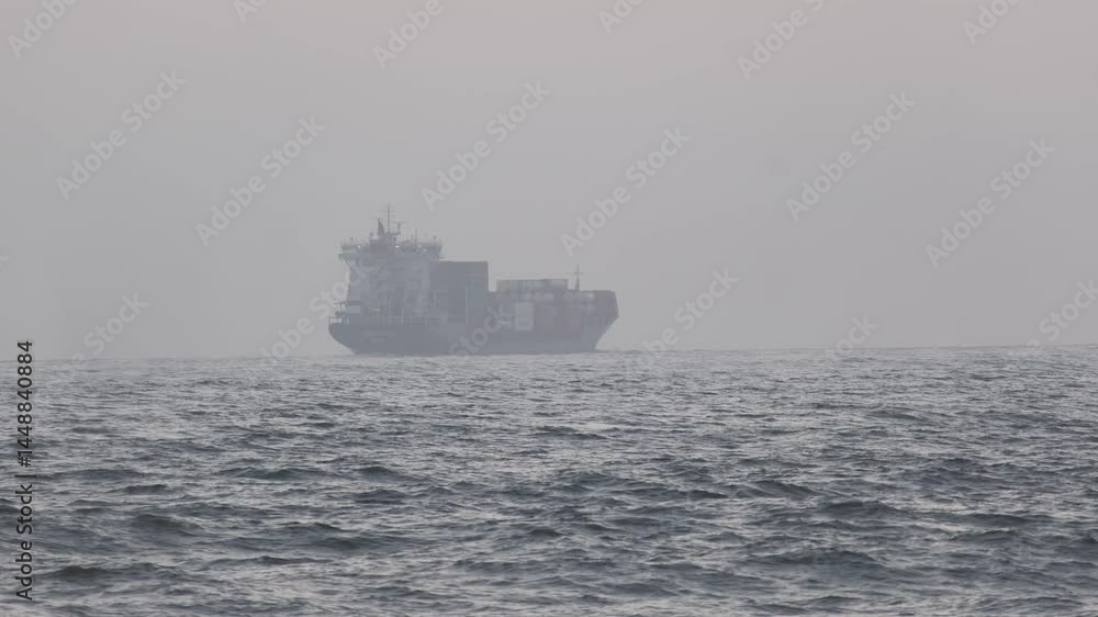 Poster hazy weather conditions create an atmospheric scene as a large container ship navigates the ocean, i