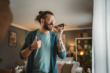 One adult man with eyeglasses stand at home use mobile phone talk