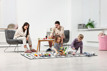 Overwhelmed parents looking at their hyperactive children at home