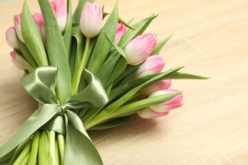 Bouquet of beautiful tulips on wooden table, closeup. Space for text