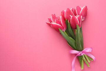 Bouquet of beautiful tulips on pink background, top view. Space for text