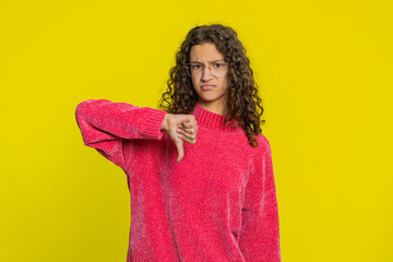 Dislike. Upset unhappy Caucasian girl showing thumbs down sign gesture, expressing discontent...