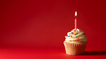 Birthday cupcake with candle on red background. Celebration theme