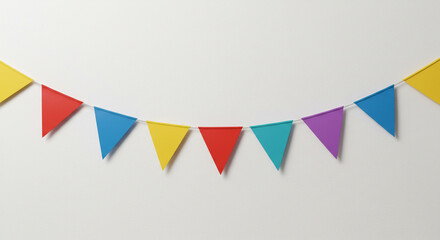 Fototapeta premium Colorful triangular pennants strung across a plain white wall, creating a festive and cheerful atmosphere, perfect for a celebration or event.