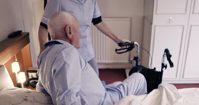 Nurse, disability and senior man in bed for healthcare, wheelchair assistance and medical support. Nursing home, retirement care and caregiver helping sick, disabled and elderly patient in bedroom