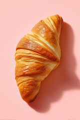 Minimalist composition of croissant with flaky layers on soft pink background. Focus on texture and color. Concept of bakery, cafe, culinary art, food photography