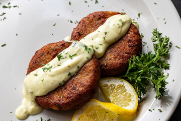Close-up of salmon croquettes and sauce.