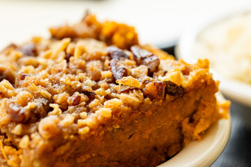 Close-up of delicious sweet potato casserole with pecan topping