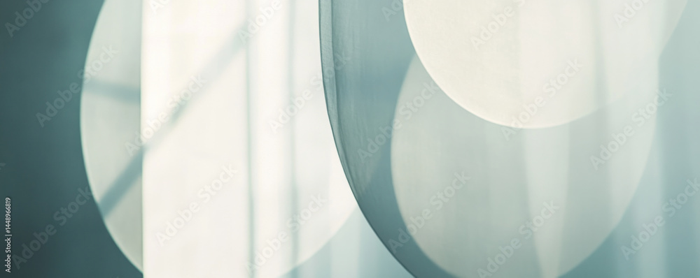 Poster a series of circles are shown in a room with a window. the circles are all different sizes and are s
