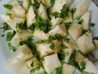 Guava fruit slices on plate with salt, green chilli, and coriander slices mix seasoning. Delicious...