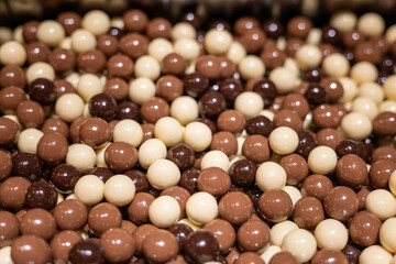 Colorful assortment of chocolate-covered candies in a shop display during an afternoon visit