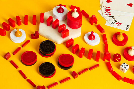 Colorful Board Game pieces and dice on a vibrant yellow background