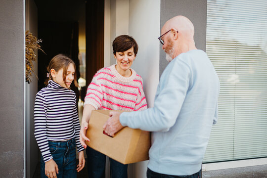 Family receiving food delivery at their doorstep