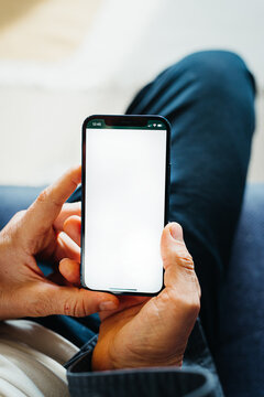 person holding smartphone with blank white screen background