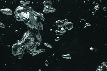 Many water bubbles on black background, closeup