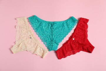 Women's underwear. Beautiful panties on pink background, flat lay