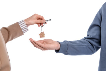 Real estate agent giving house key to new owner on white background, closeup