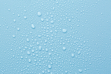 Many water drops on light blue background