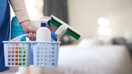 Obraz premium Woman with different cleaning supplies and products in room, closeup. Banner design and space for text