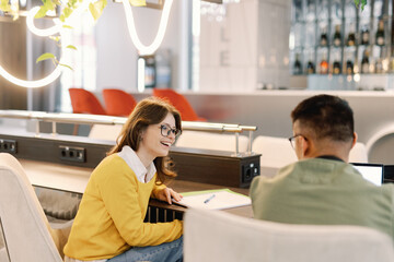 Young IT company male and female colleagues working on new project