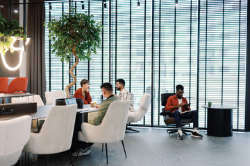 Young multiracial team of IT company working with digital devices